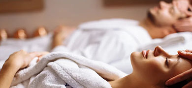 A man and woman relax together in a serene spa room