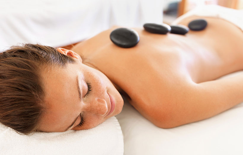 A woman relaxes on a massage table